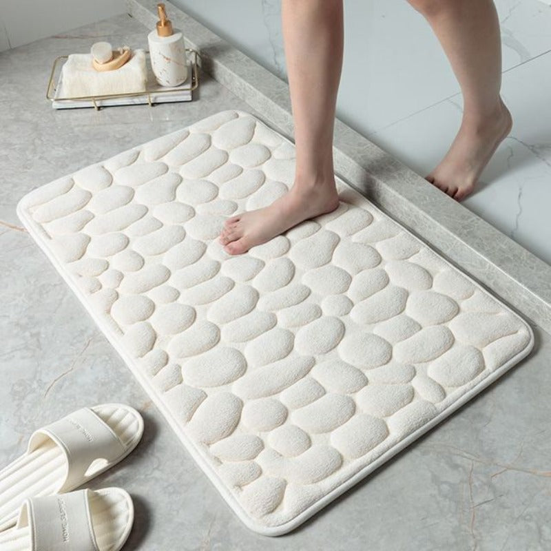 Tapis de bain super absorbant en mousse mémoire, motif pierre, séchage rapide et hygiène optimale.